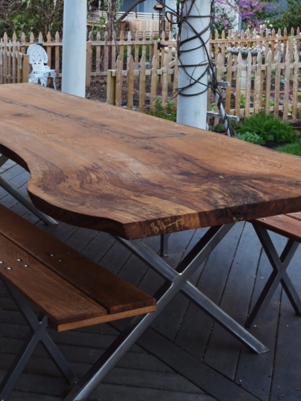 Custom-fabricated steel table with reclaimed wood top and matching benches