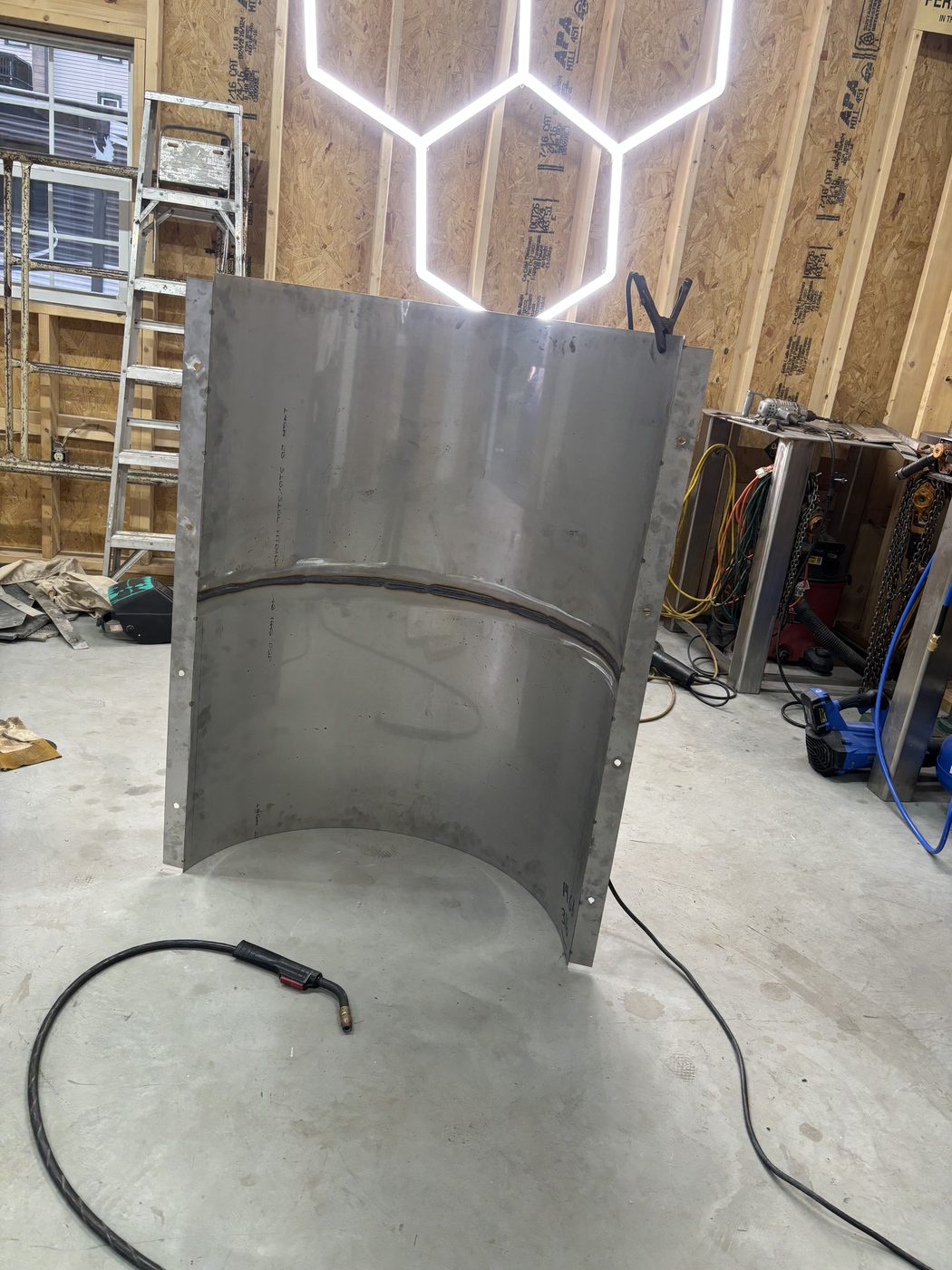 Custom stainless steel window well fabrication
